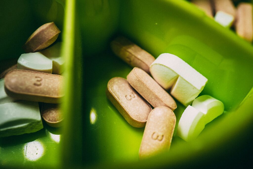 vitamin supplements in a green organizer