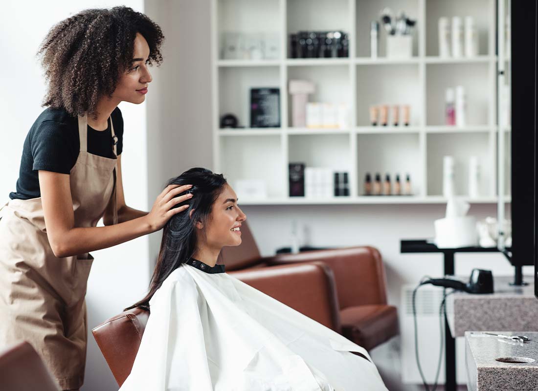 Beauty Salon Insurance - Young Woman Looking for Changes and Getting Hairstyle Advice from Stylist at a Beauty Salon