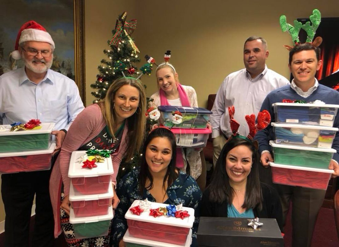 Commercial Lines Assistant Account Manager - Southern States Insurance Team Members Having Fun Holding Party Supplies at a Company Christmas Party