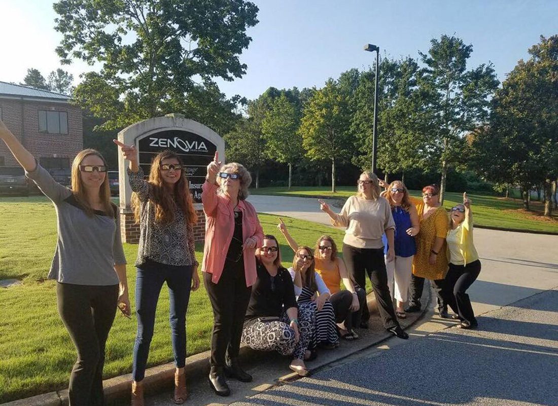 Douglasville, GA - Group Portrait of Southern States Insurance Staff in Douglasville Georgia Wearing Solar Eclipse Glasses While Standing Outside the Office