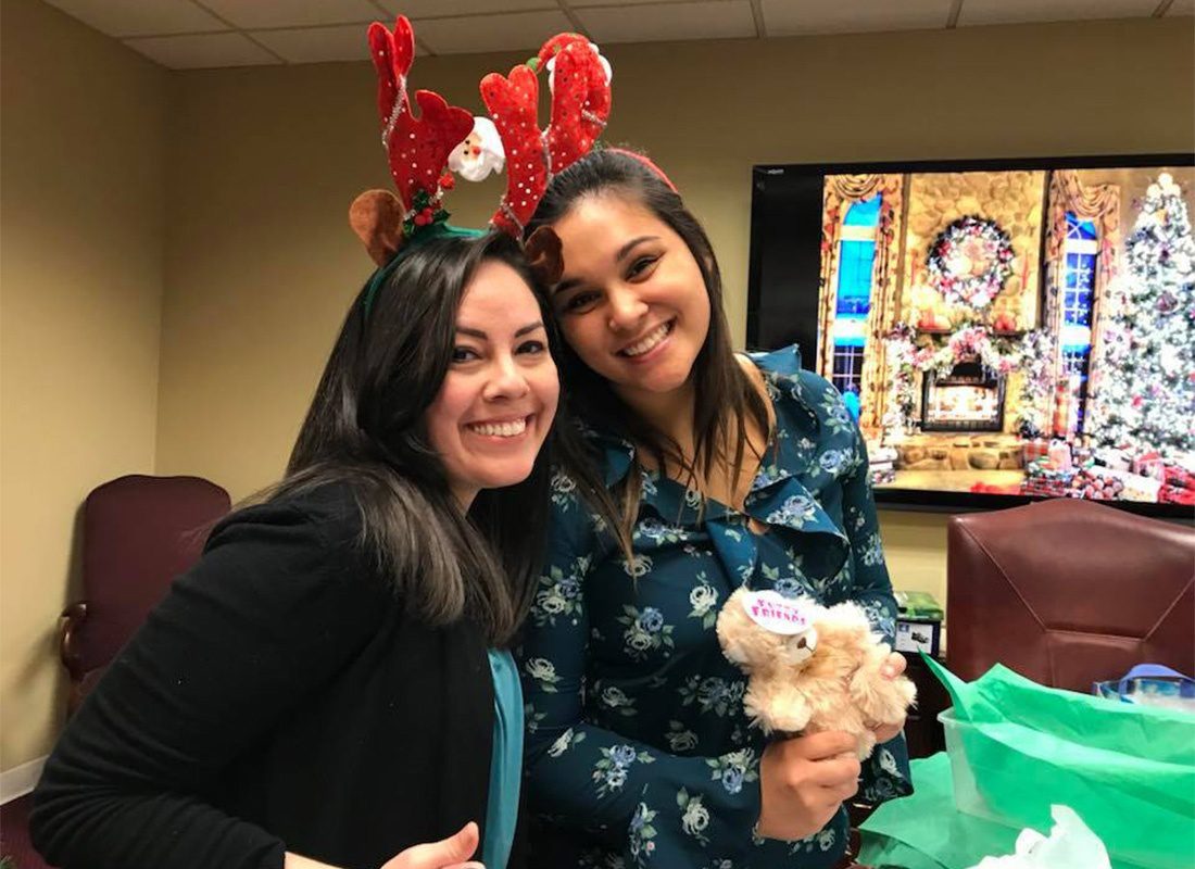 Personal Insurance Inside Sales Agent - Portrait of Team Members Stefanie and Jessie at the Office Christmas Party Filling Up Chriistmas Shoeboxes