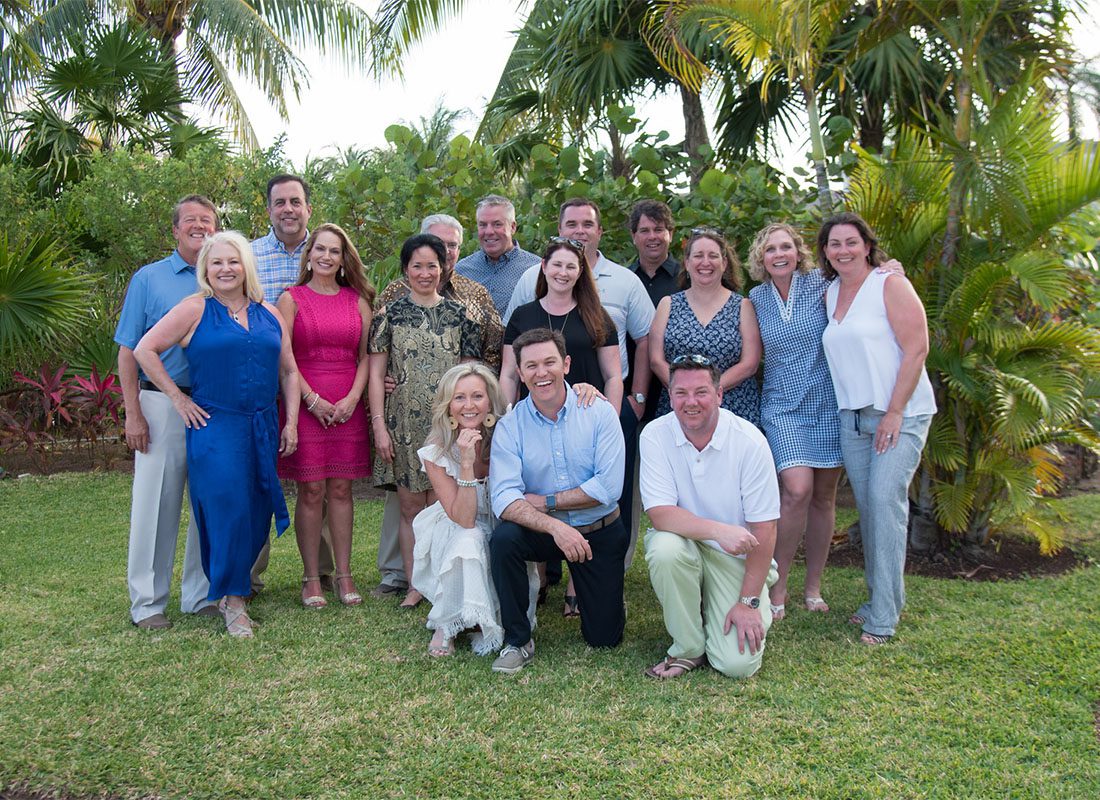 Personal Lines Assistant Account Manager - Smiling Group Photo of Southern States Insurance Team Next to Palm Trees at a Trip to Cancun Mexico