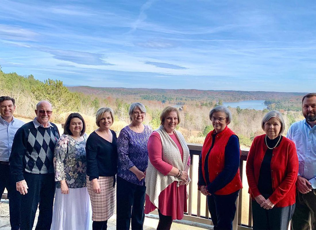 Toccoa, GA - Portrait of Smiling Southern States Insurance Team Members from the Toccoa Georgia Office Standing at a Scenic Lookout Point with Colorful Trees in the Background