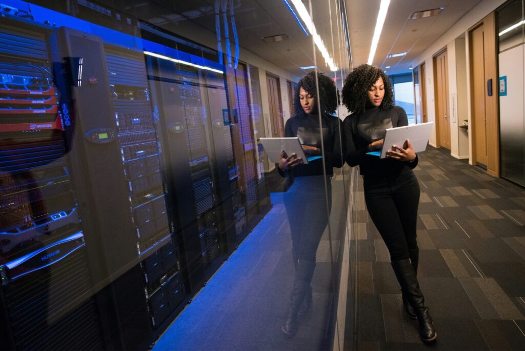 cyber insurance for technology companies - woman standing next to servers